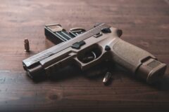 black and silver semi automatic pistol on brown wooden table