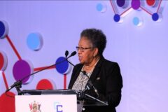 CARICOM Secretary-General, Dr. Caria Barnett deliver welcome remarks at the regional symposium.