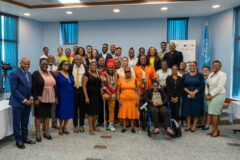 A photo of persons standing together for a photo opportunity with various disabilities. 
