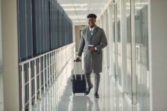 Image of man walking and pulling hand luggage